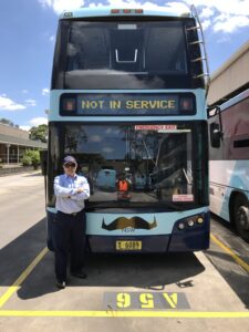 CDC Staff Standing In Front Of A Hillsbus Bus With Movember Moustaches