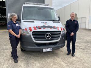 NPT Staff Standing In Front Of A NPT Ambulance With Movember Moustaches